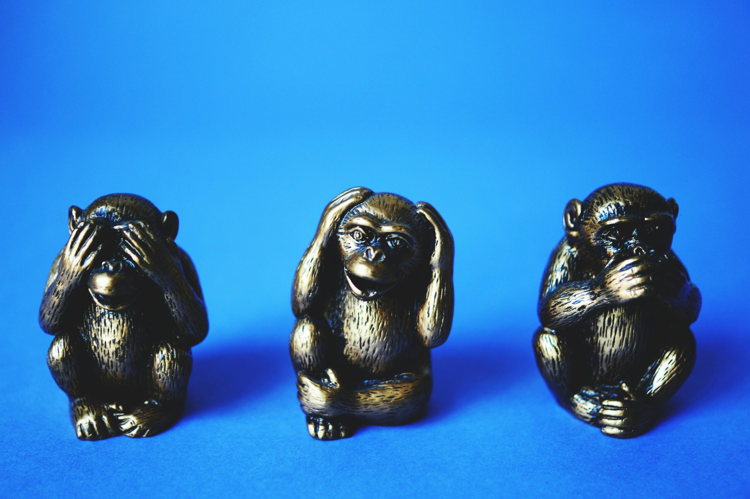 Close-up of the three wise monkeys bronze figurines symbolizing see no evil, hear no evil, speak no evil.